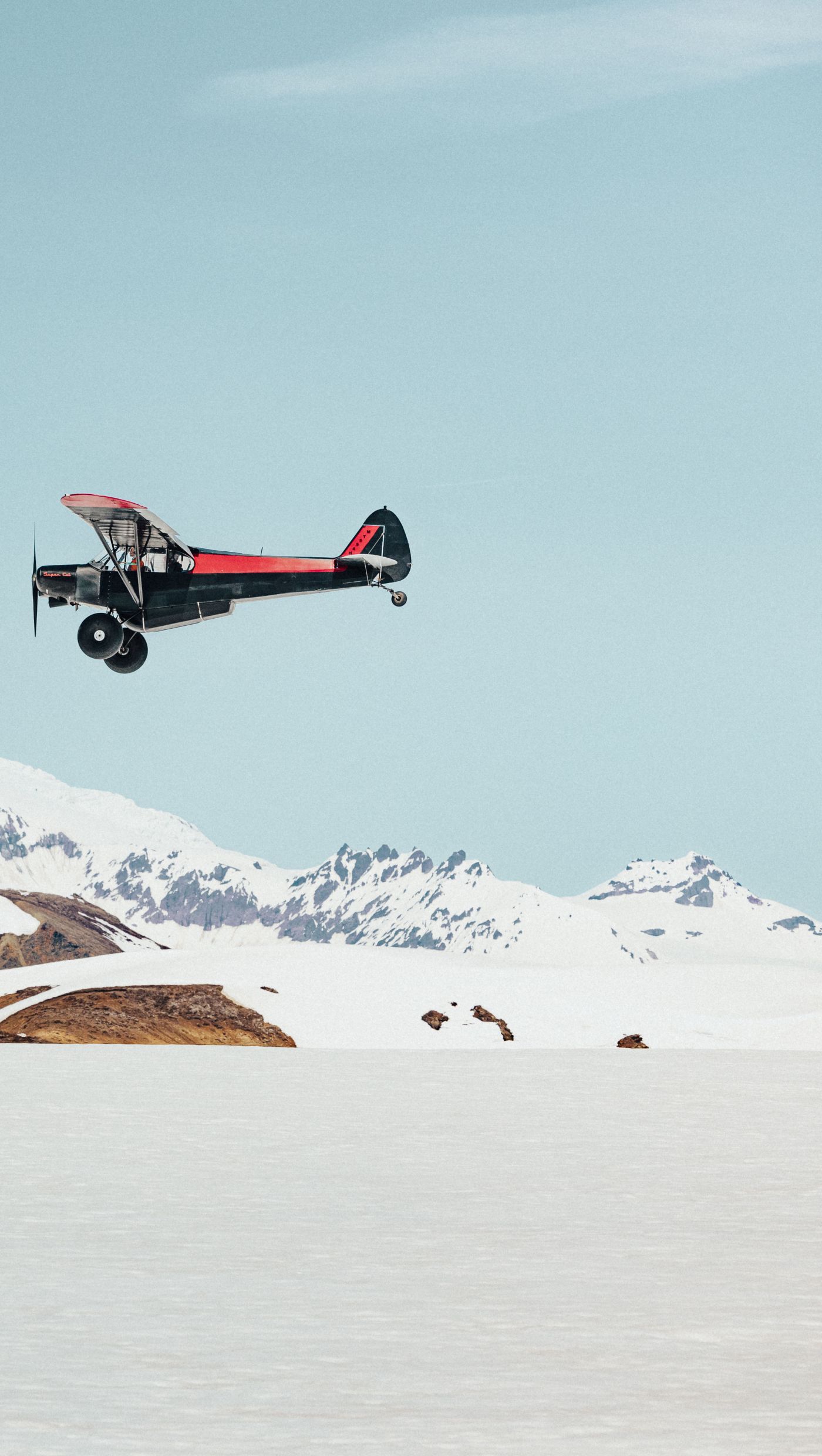 Aircraft in front of a snow-covered volcano in Alaska